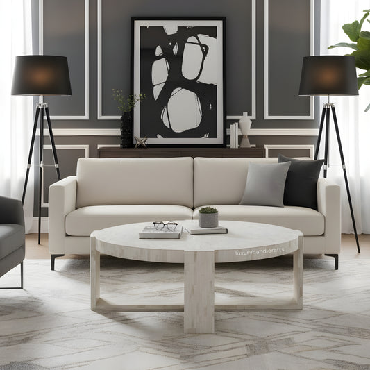 Modern living room with a beige sofa, round coffee table, and abstract art on the wall.