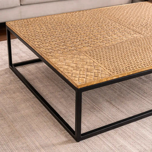 Elio Brass center table with patterned brass top and black metal frame.