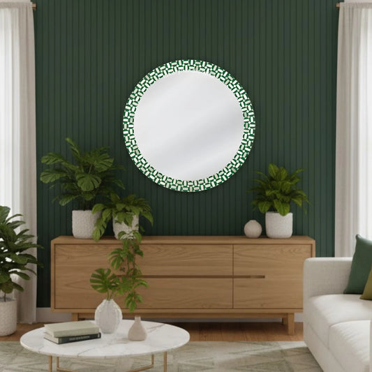 Round decorative mirror with green geometric pattern on a wall in a living room.
