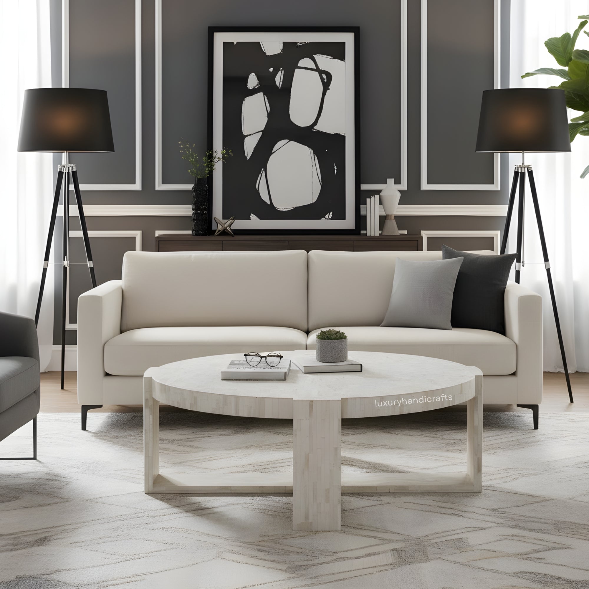 Modern living room with a beige sofa, round coffee table, and abstract art on the wall.