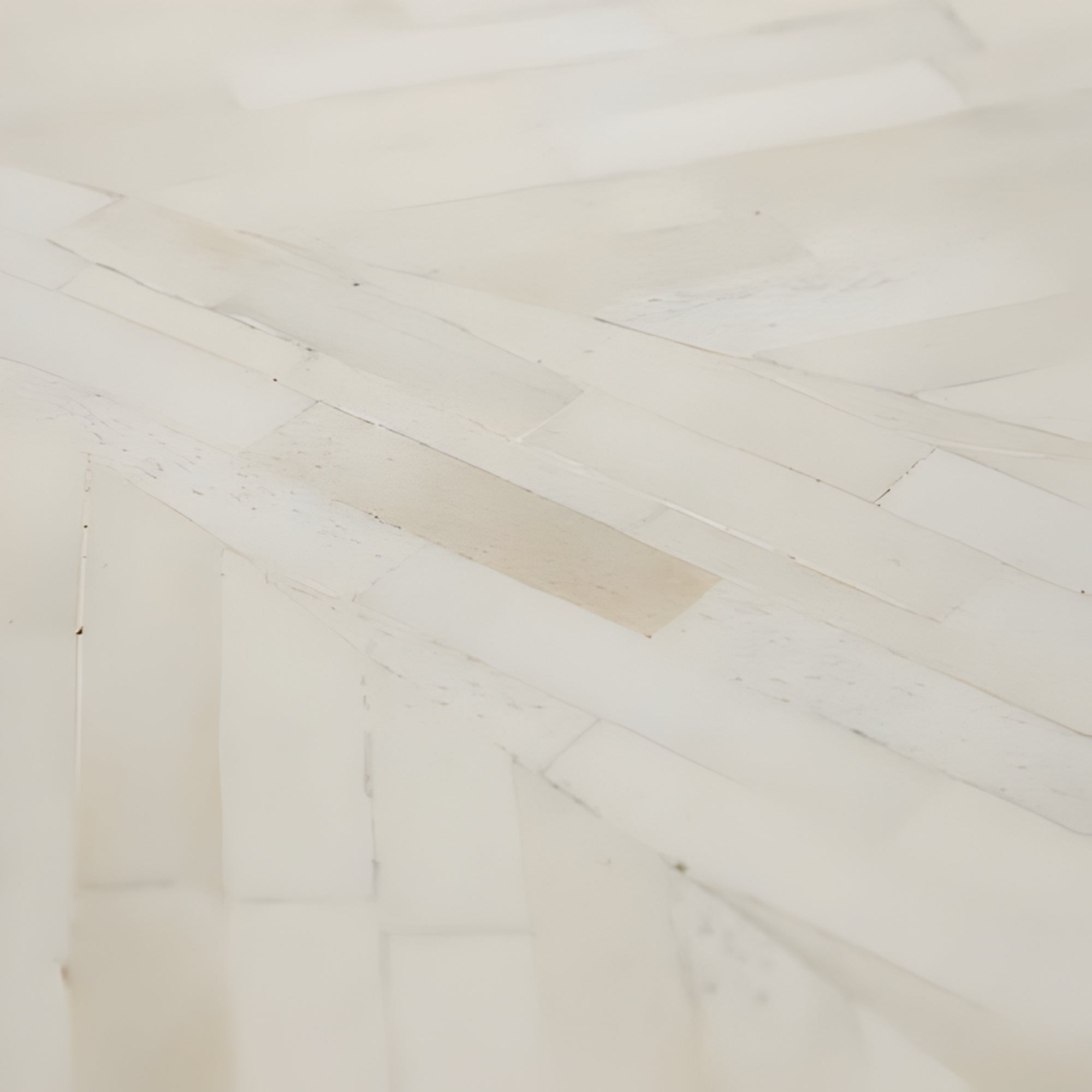 Close-up of a wooden floor with a herringbone pattern