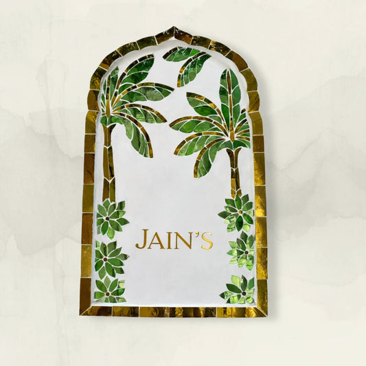 Decorative nameplate with palm tree design and name on a white background
