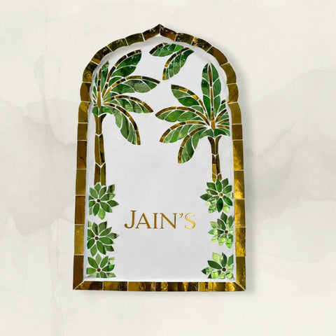Decorative nameplate with palm tree design and name on a white background