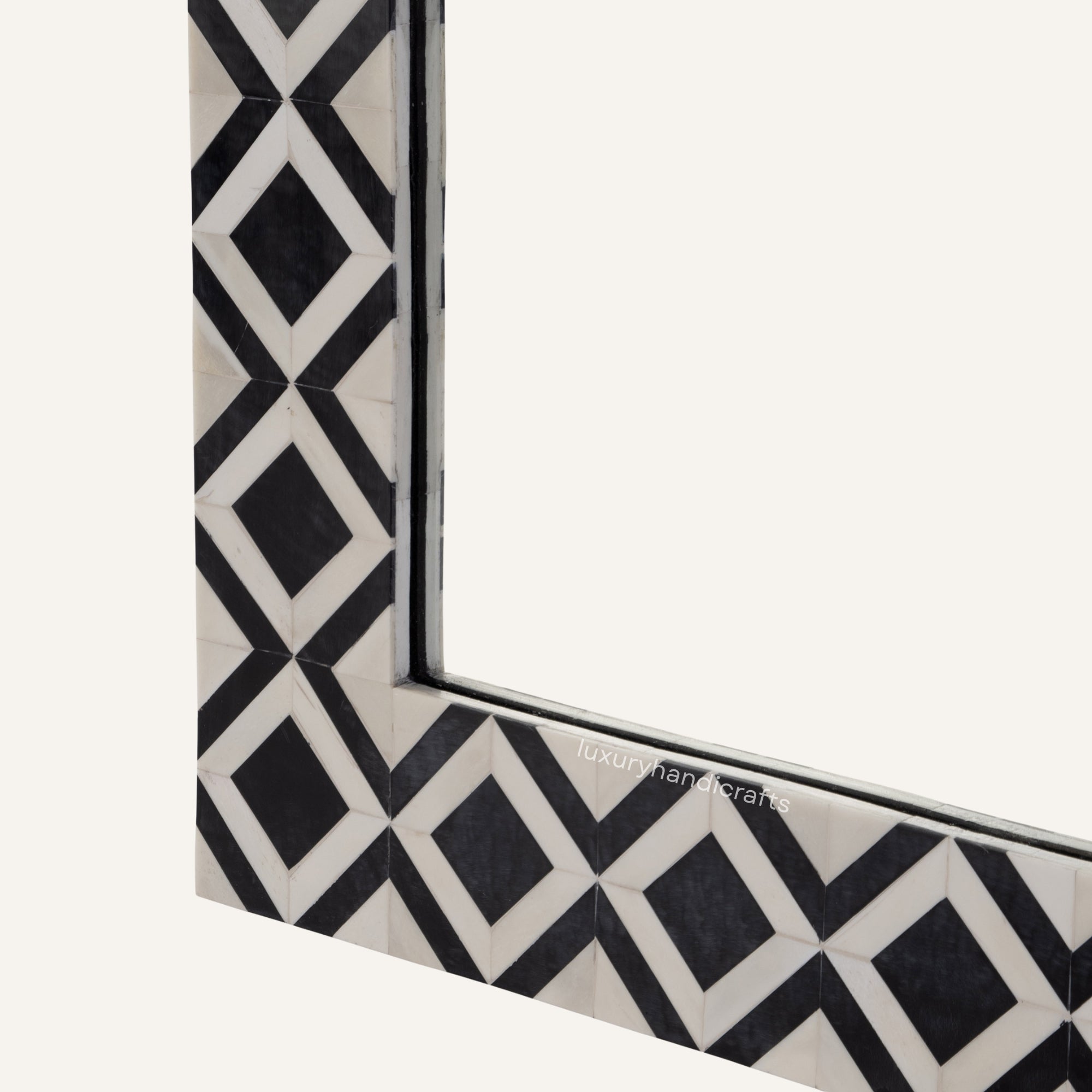 Decorative mirror with black and white geometric pattern on a white background