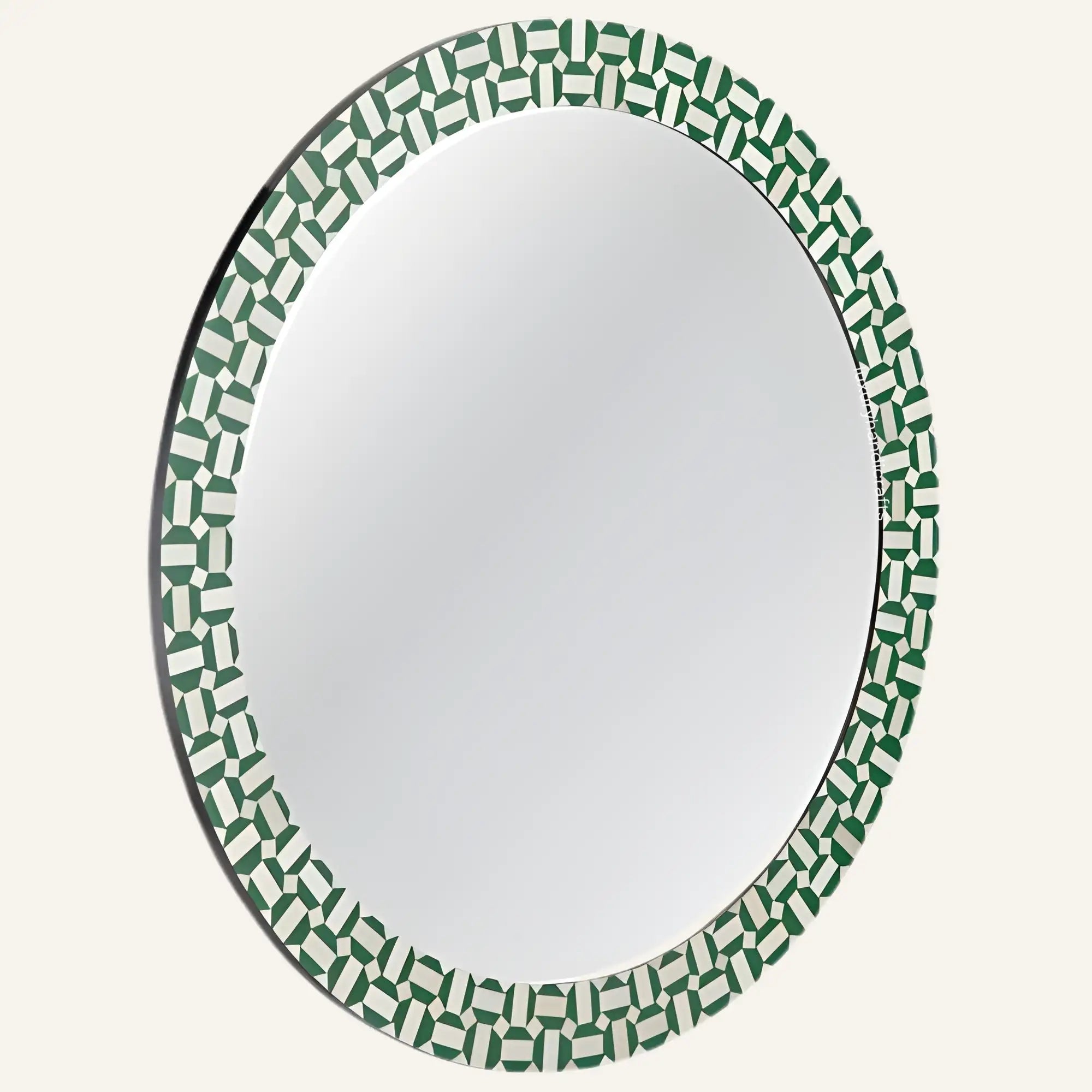 Round mirror with a green and white geometric pattern on a white background
