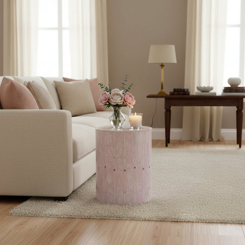 Round stool with a pink and gold pattern on a white background