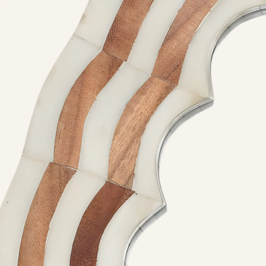 Close-up of a decorative wall piece with wavy patterns on a white background