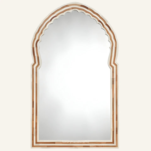 Arched mirror with decorative wooden frame on a white background