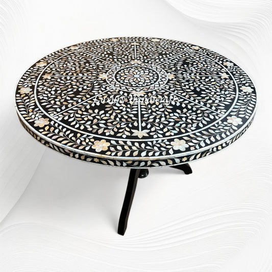 Detail of the flower centre mother of pearl inlay on the black dining table top