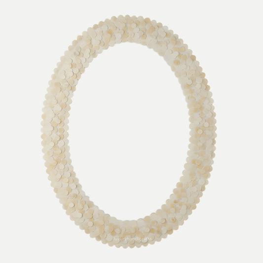 Oval mirror with a shell-like frame on a white background