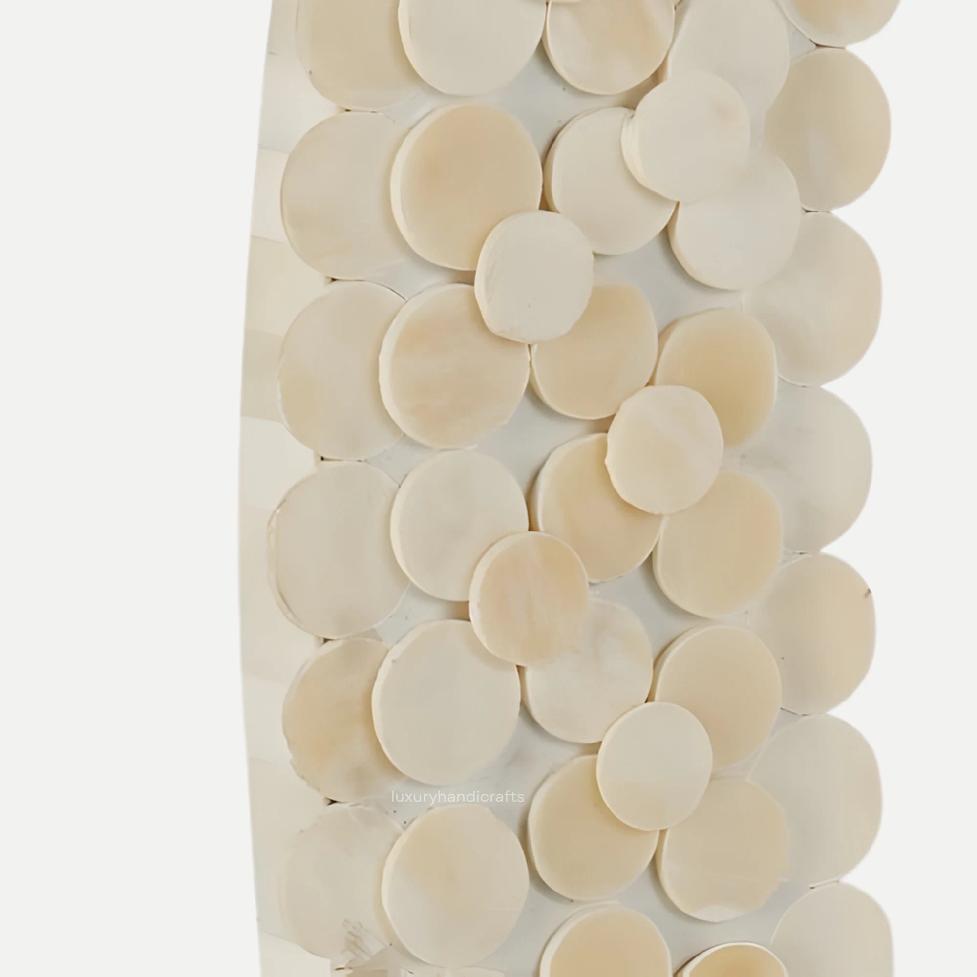 Decorative wall art with circular beige tiles on a white background