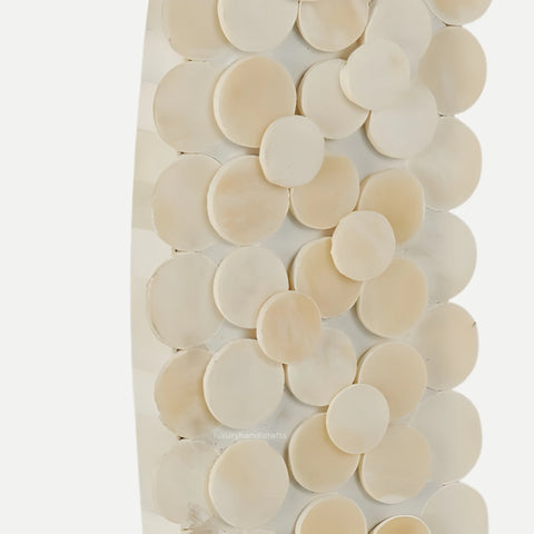 Decorative wall art with circular beige tiles on a white background