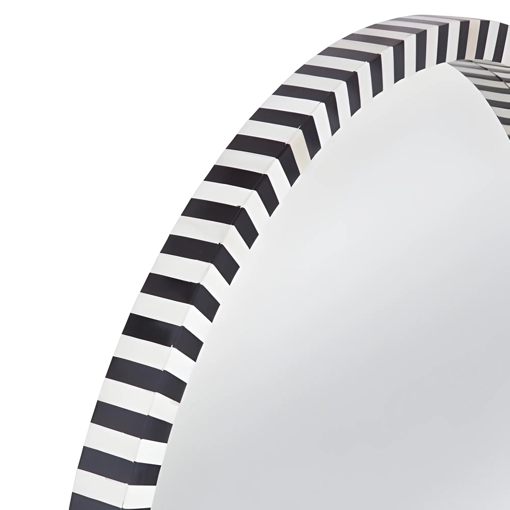 Close-up of a black and white striped paper plate on a white background