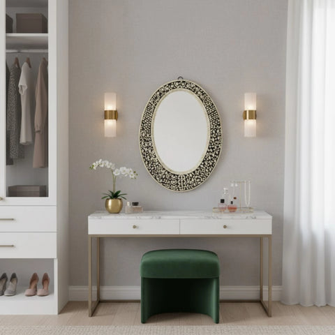Modern bedroom with a vanity table, mirror, and green stool.