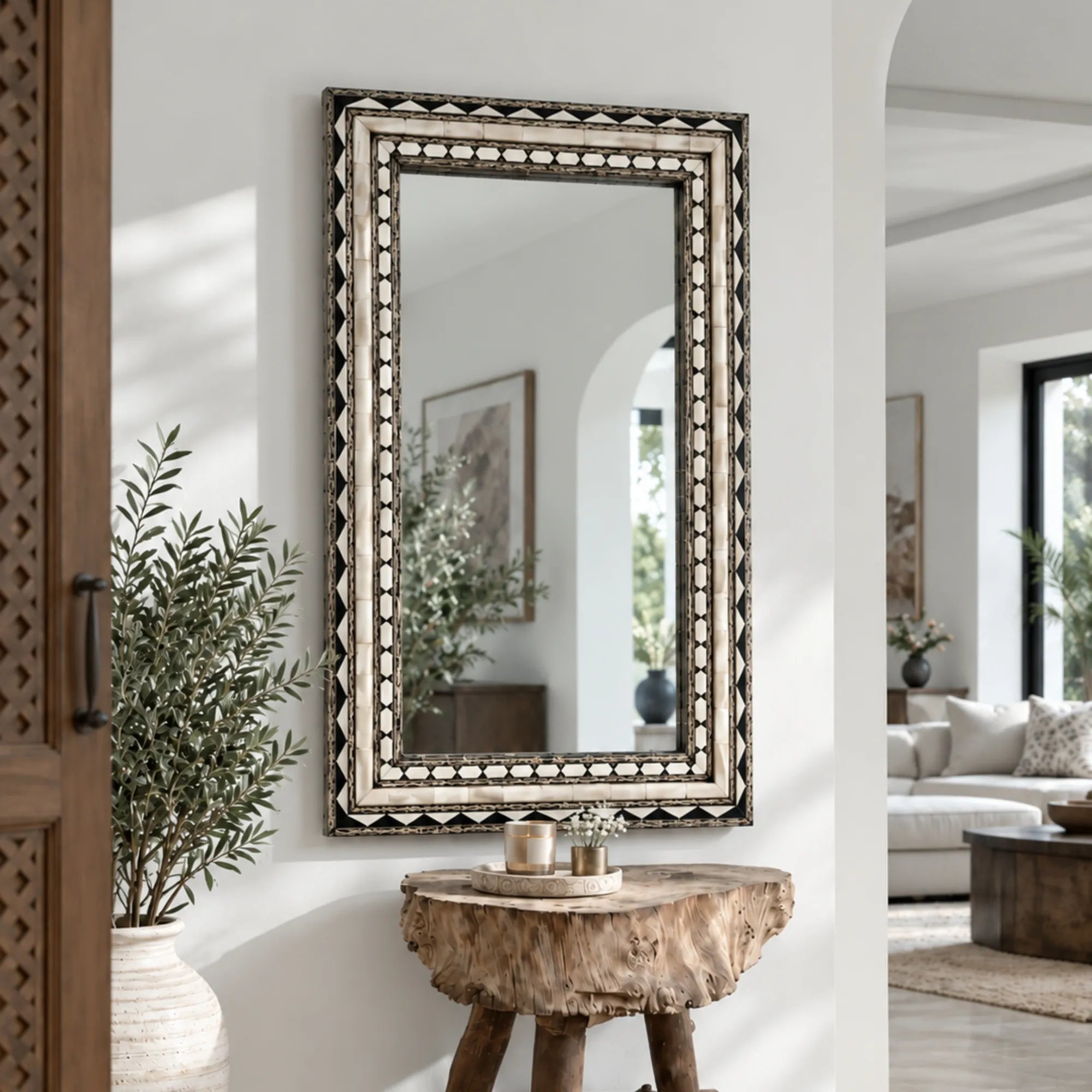 Handcrafted Bone and Brass Inlay Wall Mirror featuring geometric patterns in a luxury living room entryway