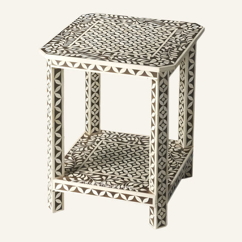 Decorative side table with geometric pattern on a white background