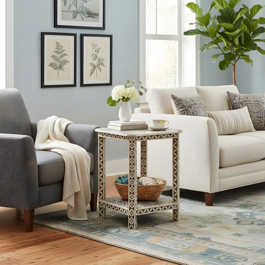 Living room with gray armchair, white sofa, and decorative side table.