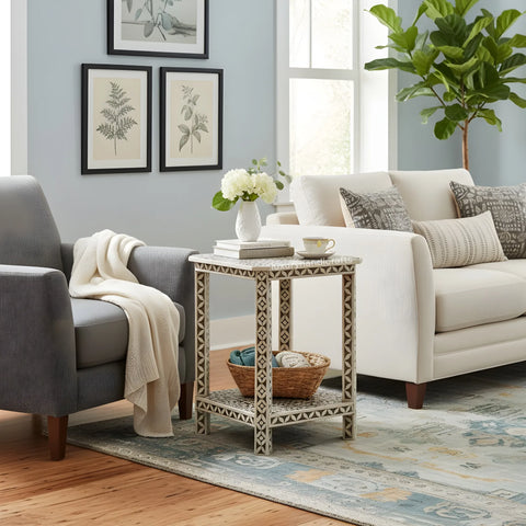 Living room with gray armchair, white sofa, and decorative side table.