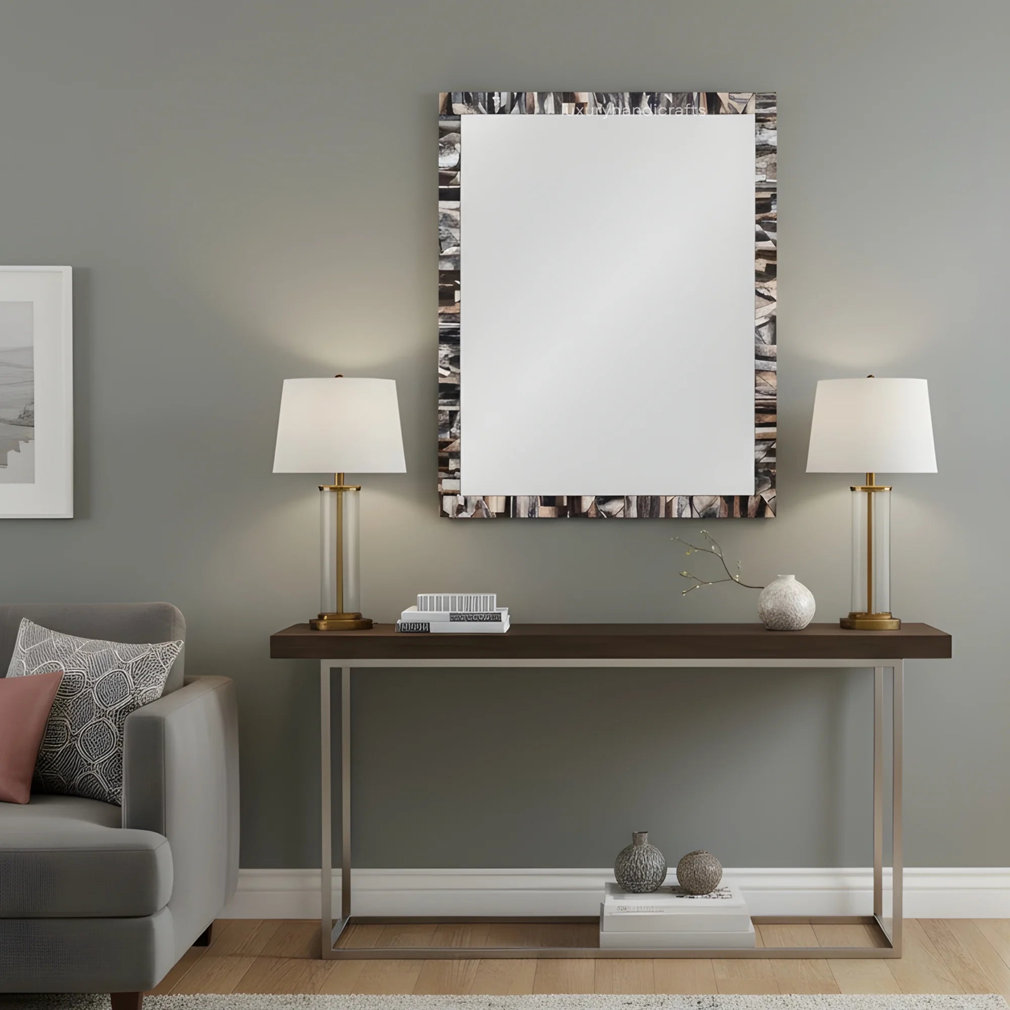 Modern living room with a console table, lamps, and decorative items against a gray wall.