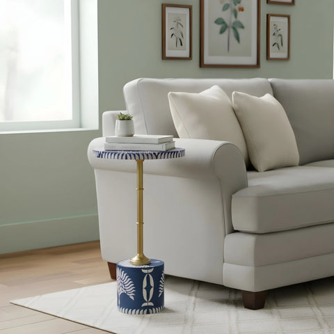Living room with a gray sofa, decorative side table, and framed artwork on the wall.