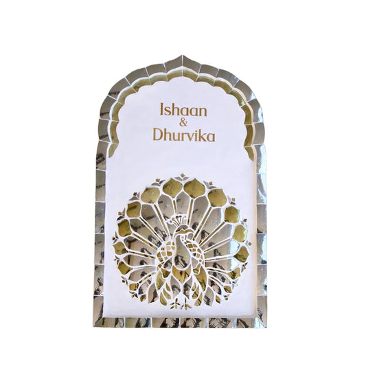 Decorative nameplate with intricate gold patterns and names on a white background