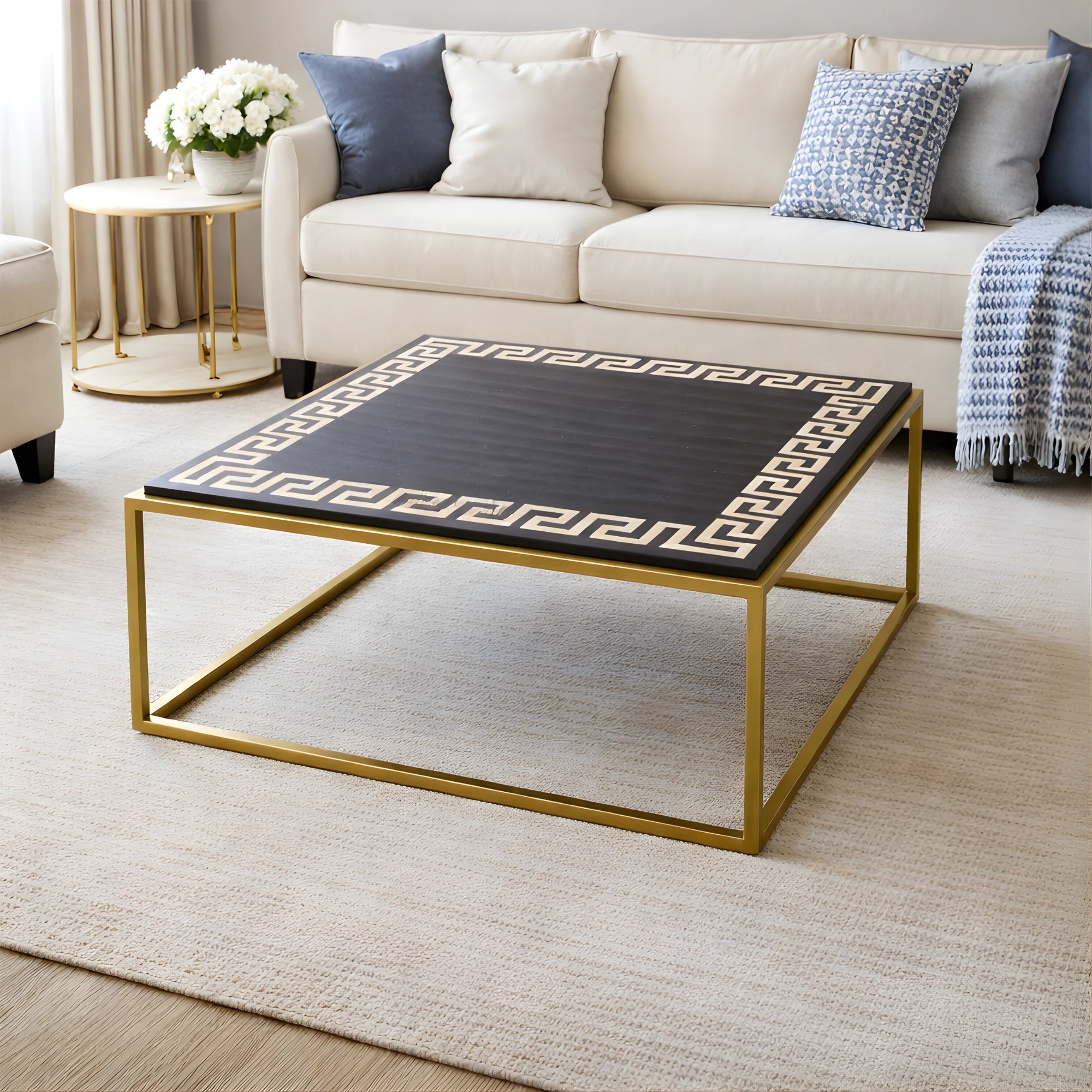 Decorative coffee table with gold frame and black patterned top in a living room setting.