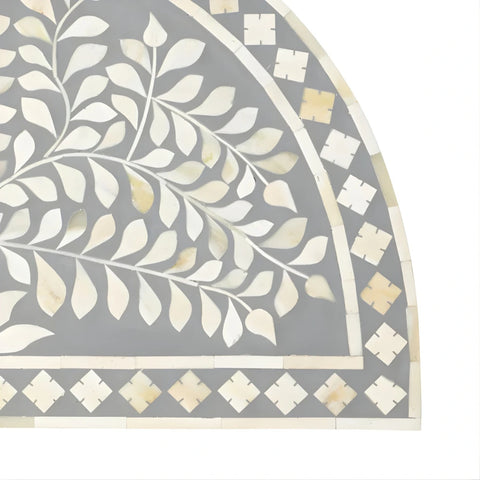 Handcrafted bone inlay detail on half moon side table surface